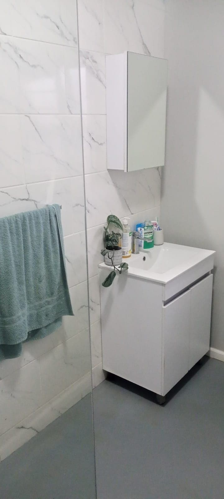 Bathroom with marble-look tiles and vanity