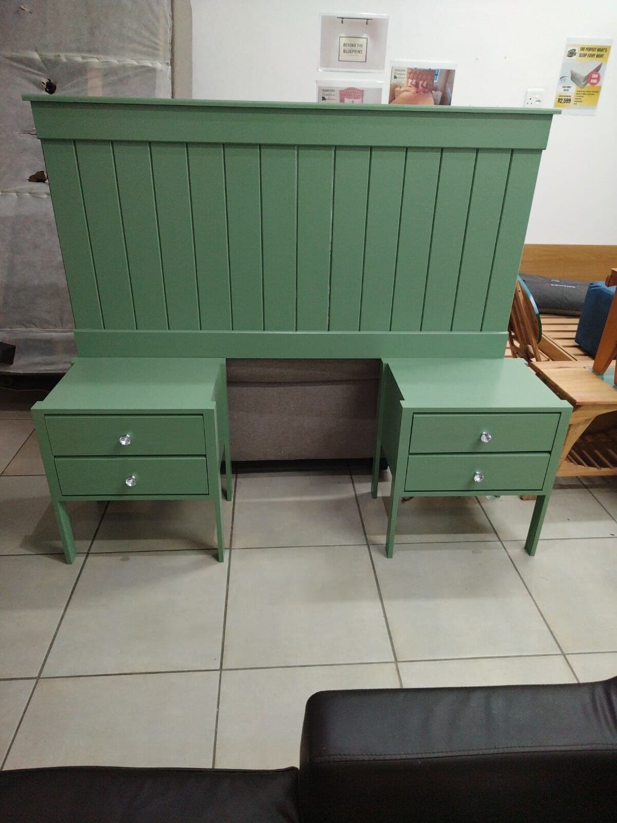Green panelled headboard with attached pedestals