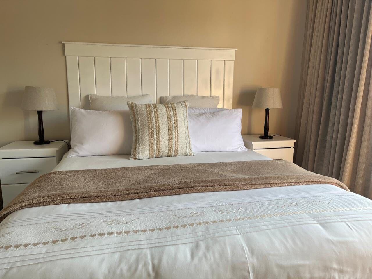 White panelled headboard fitted in a bedroom