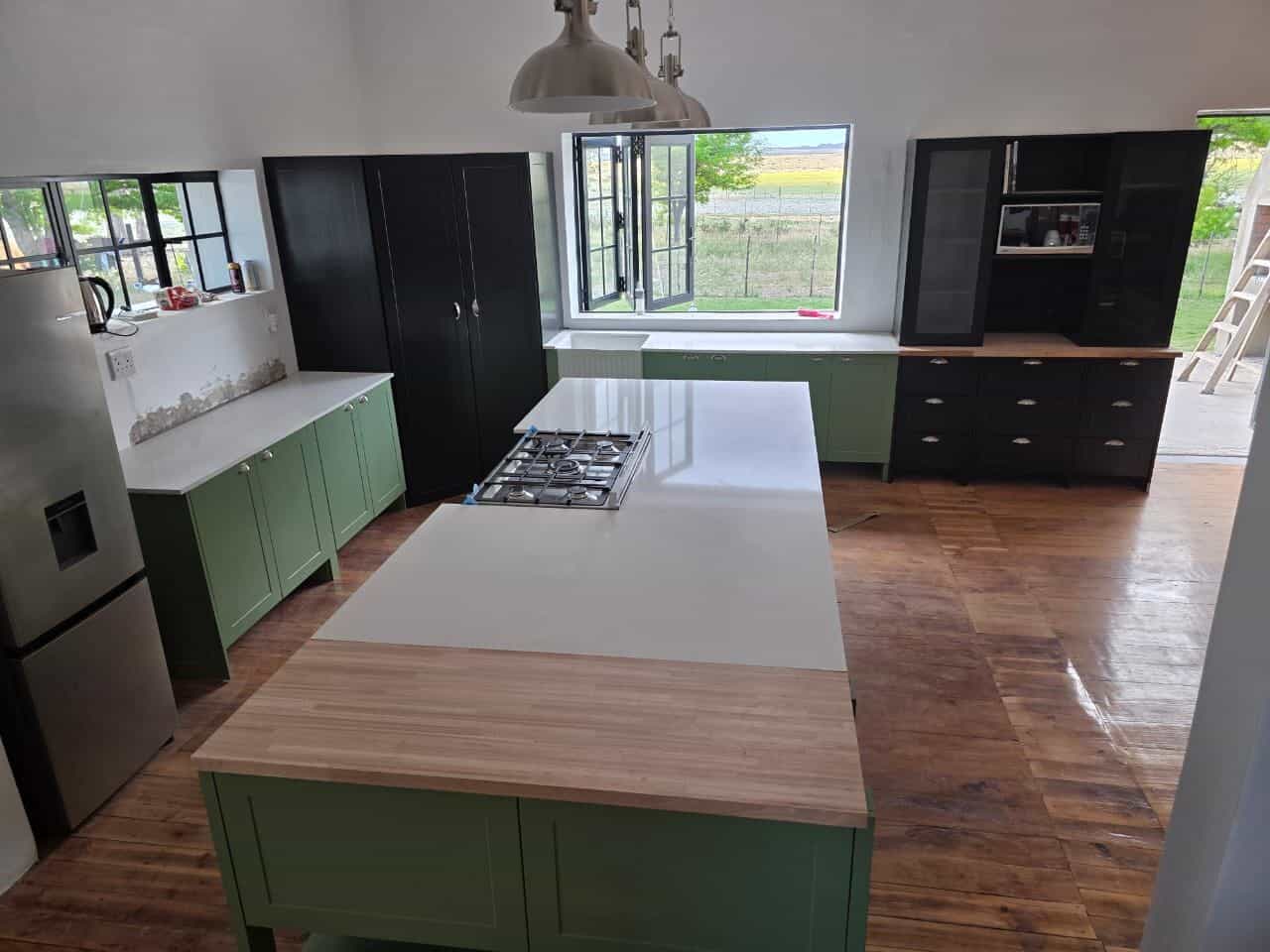 Green shaker kitchen with island, made and fitted by Elite Home Finishes